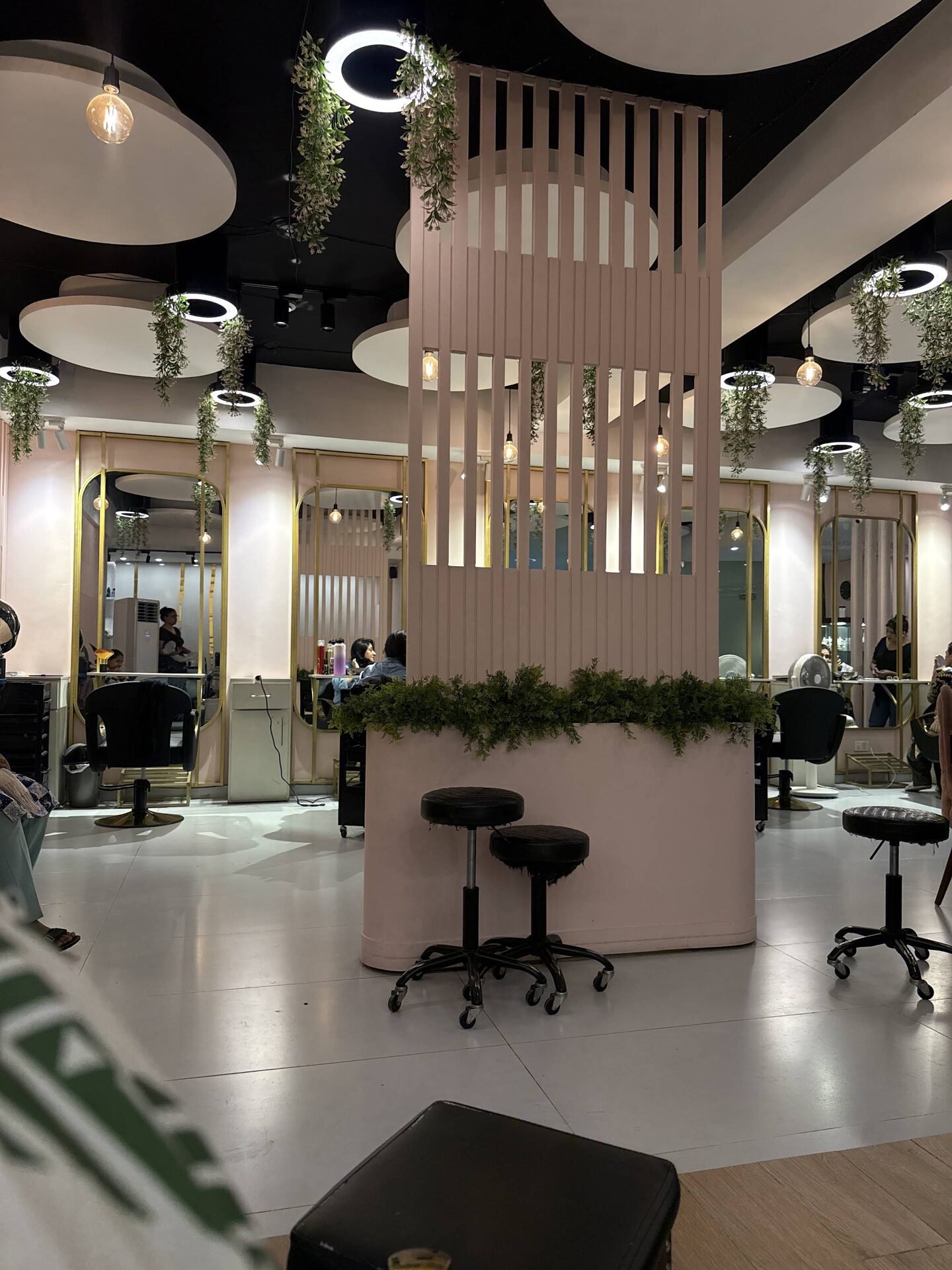 Salon lounge with slatted pink room divider