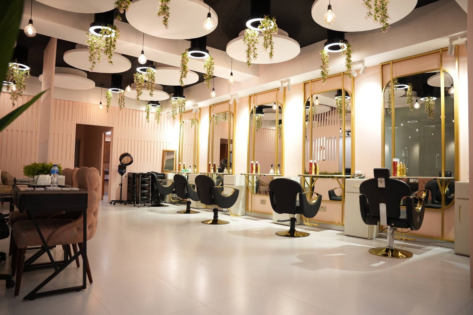 Gold-framed styling stations at HER salon